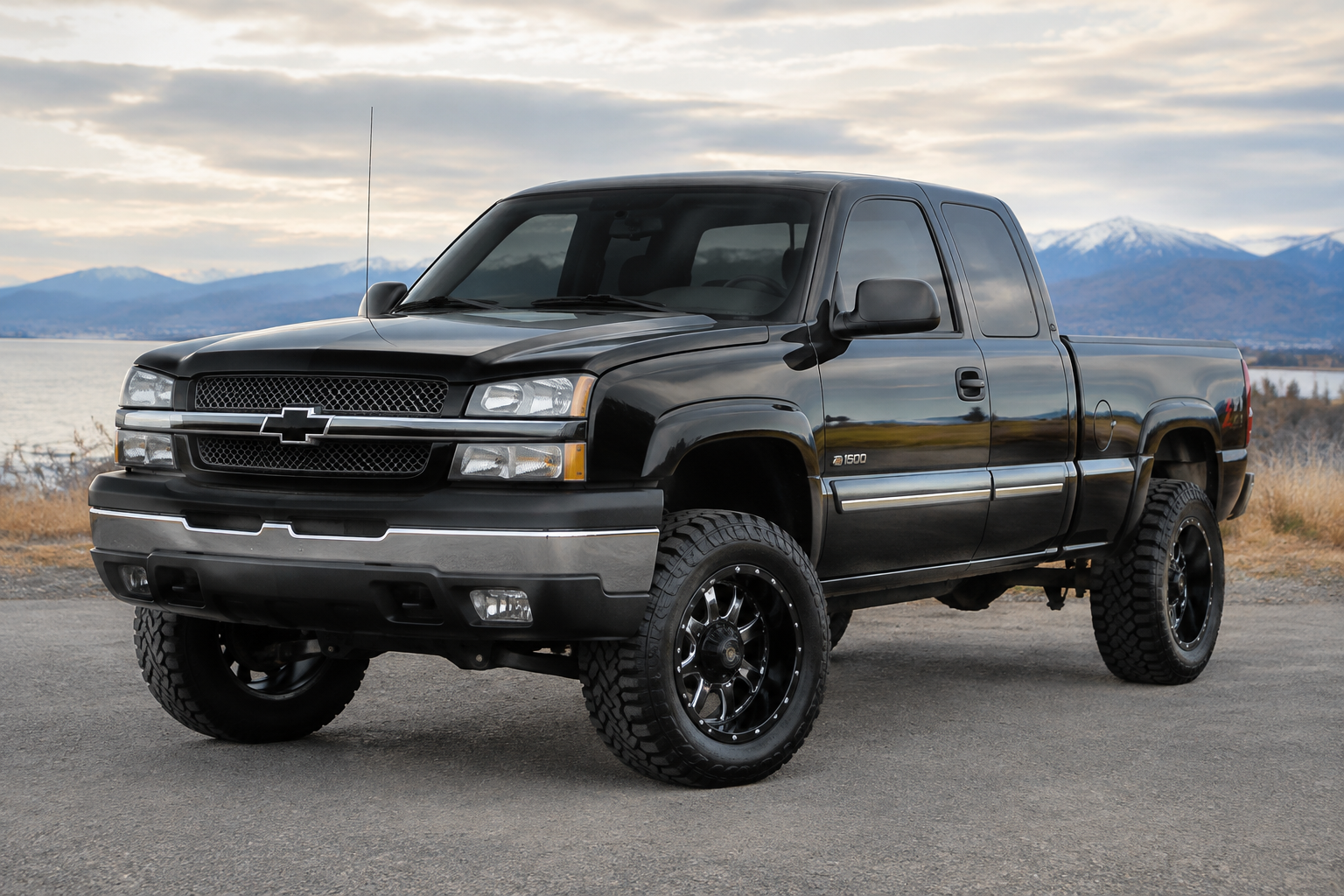 2005 Chevy Silverado 1500 with a 3 inch lift, black with chrome outline 17 in...